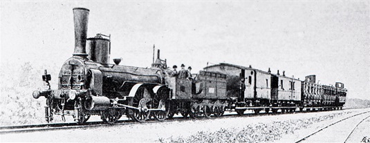 Snímek lokomotivy z přelomu 19. století. Parní vlaky zůstaly na trati více než sto let, elektrifikace dráhy mezi Prahou a Berounem přišla na řadu až v 70. letech 20. století. 